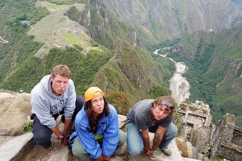 Tourists at the top of the mountain Huayna Picchu