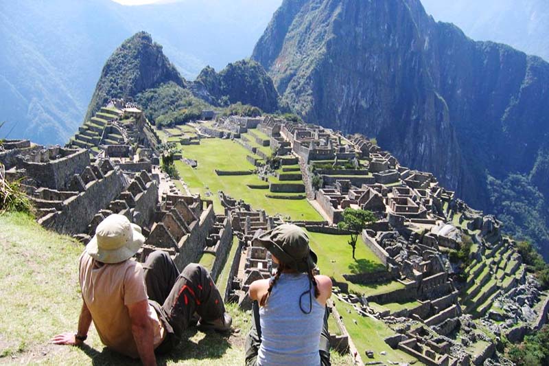 Tourists appreciating the majesty of the citadel of Machu Picchu