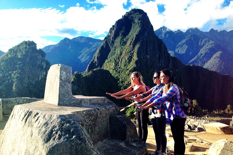 Turistas sintiendo al energía de Machu Picchu