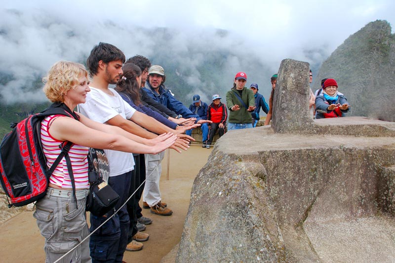 Visitors feeling the energy of the Intihuatana