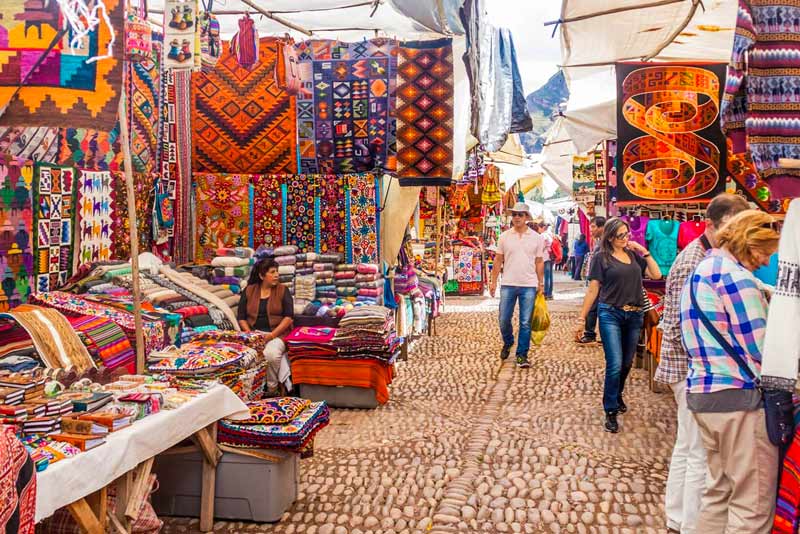 Turista observando productos en el Mercado de Pisac