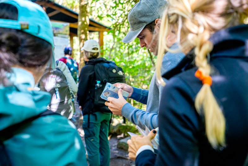 Tourists checking their passports at the Inca Trail checkpoint