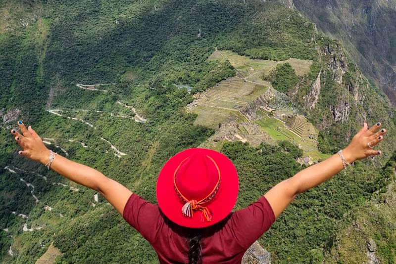Tourist observing from the top of Huayna Picchu