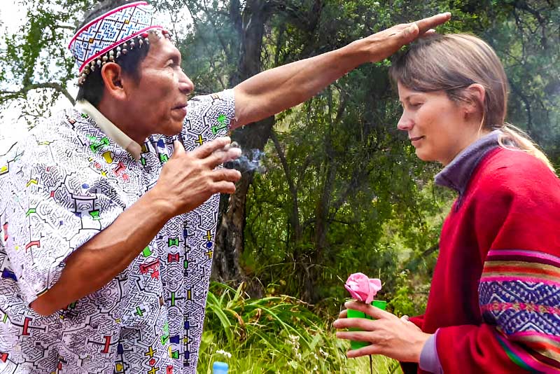 The Shaman guiding the tourist during the Ayahuasca ceremony