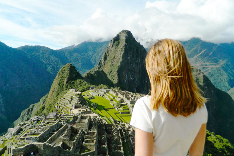 Tourist observing the Inca citadel of Machu Picchu