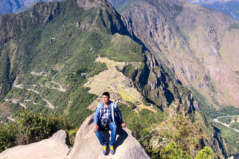 Tourist at the top of Huayna Picchu mountain