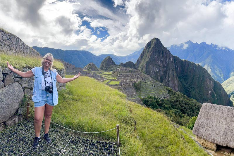 Happy tourist at the Inca citadel of Machu Picchu